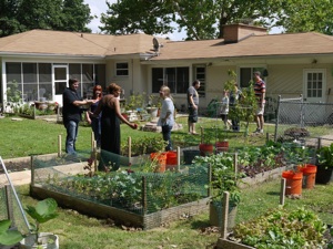 People touring a backyard garden on the 2011 Sustainable Backyard Tour