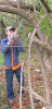 Boy saws branch over head