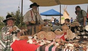 Vendors dressed in Pioneer-era clothes at a booth on Prairie Day