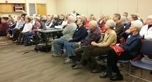 A group of people watching a presentation