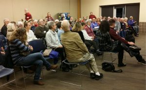 A group of people watching a presentation